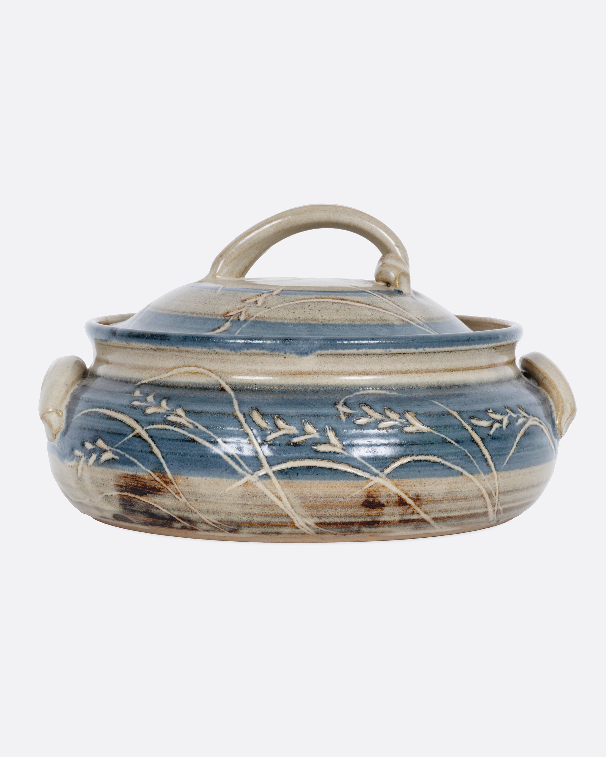 A blue and gray casserole dish with a domed lid and handles. Shown from the front.
