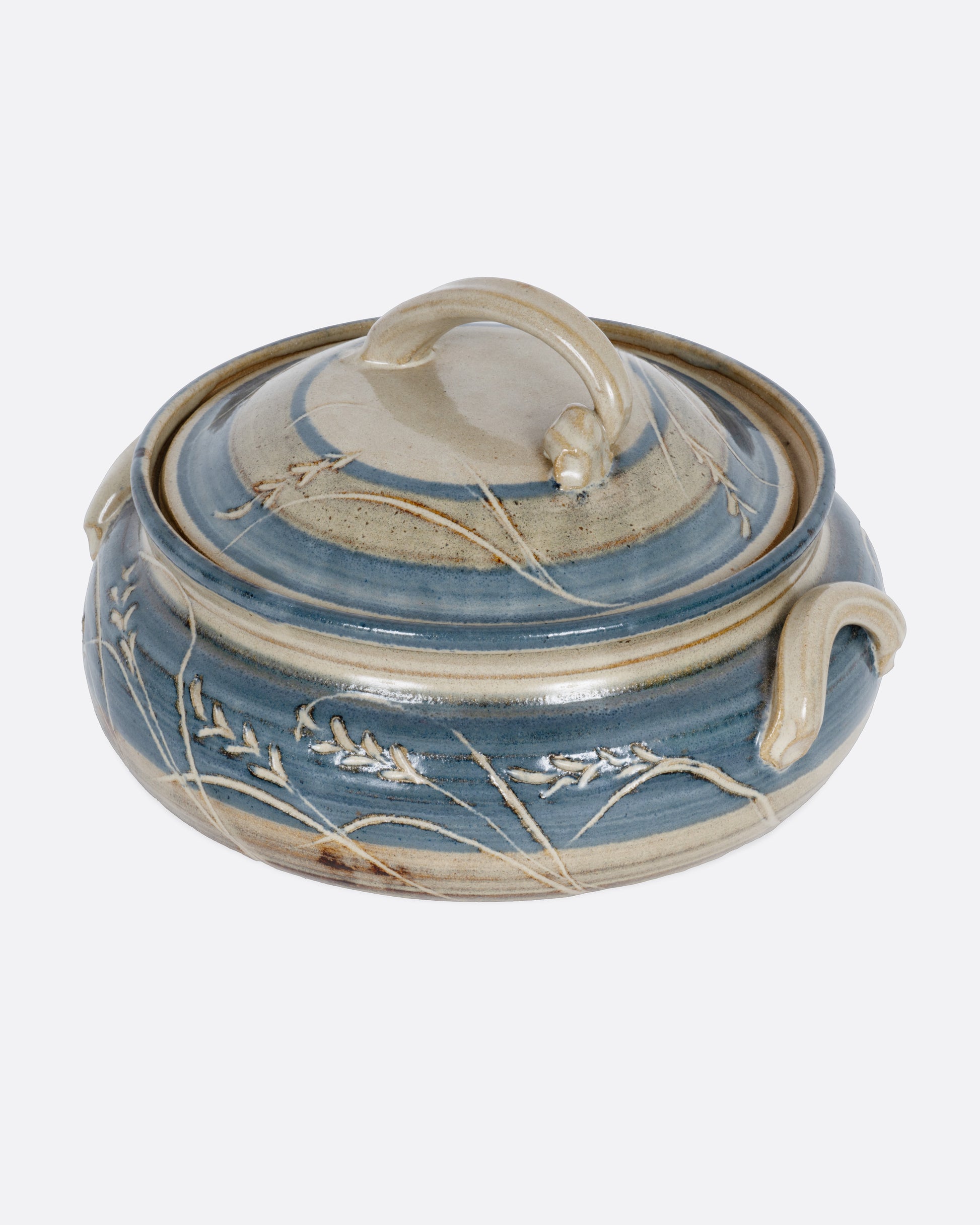 A blue and gray casserole dish with a domed lid and handles. Shown from the side.