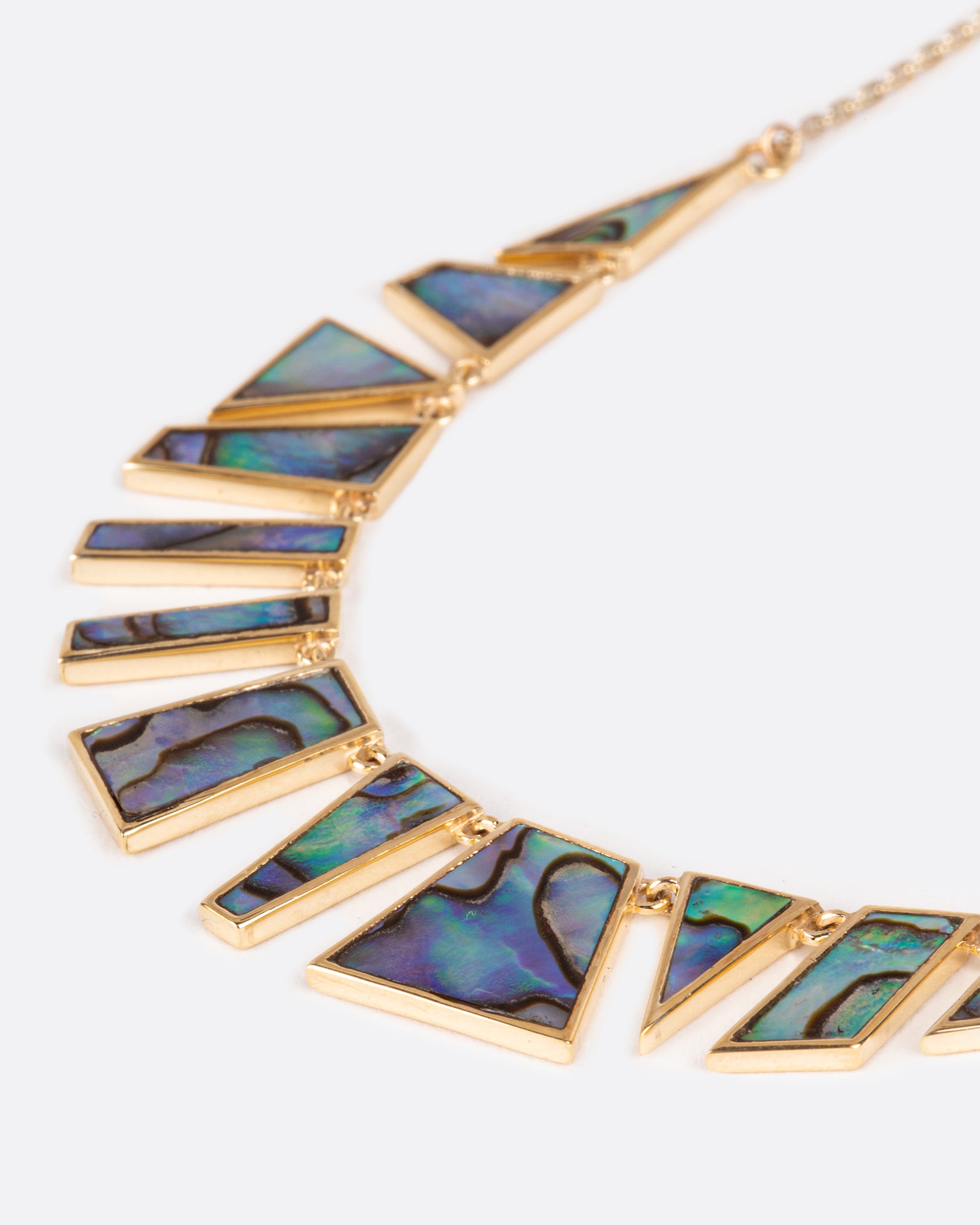 Geometric slices of abalone fit together in this mosaic necklace.