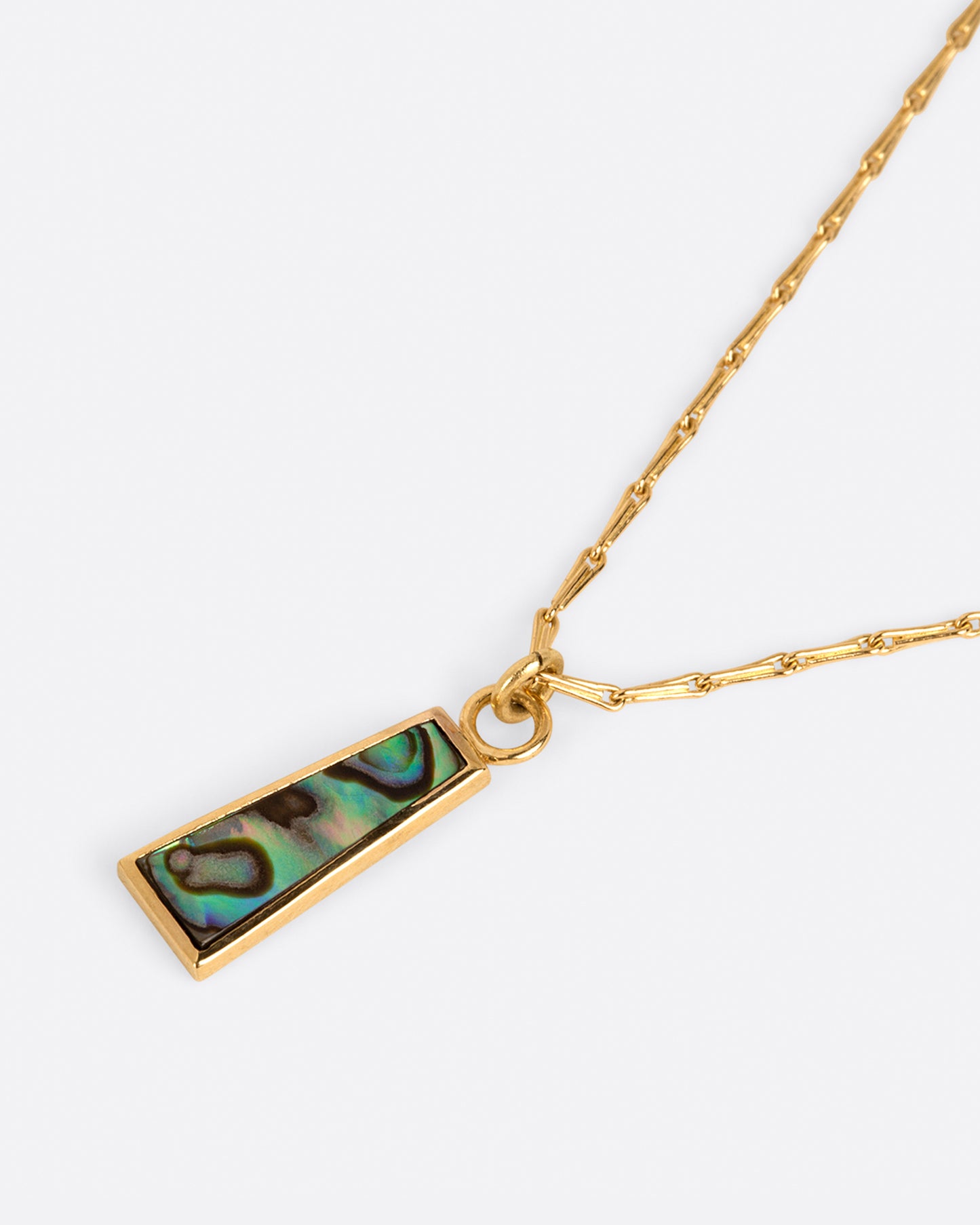 A long abalone trapezoid pendant hangs on a beautiful barley corn chain.