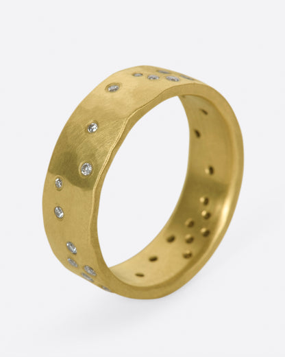 Yellow gold diamond constellation band, angled view of the band showing diamonds scattered around the outside