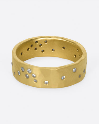 Yellow gold diamond constellation band, front view showing a cluster of diamonds and the open backs inside