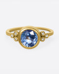 The stunning, periwinkle blue sapphire at the center of this ring is the star of the show.