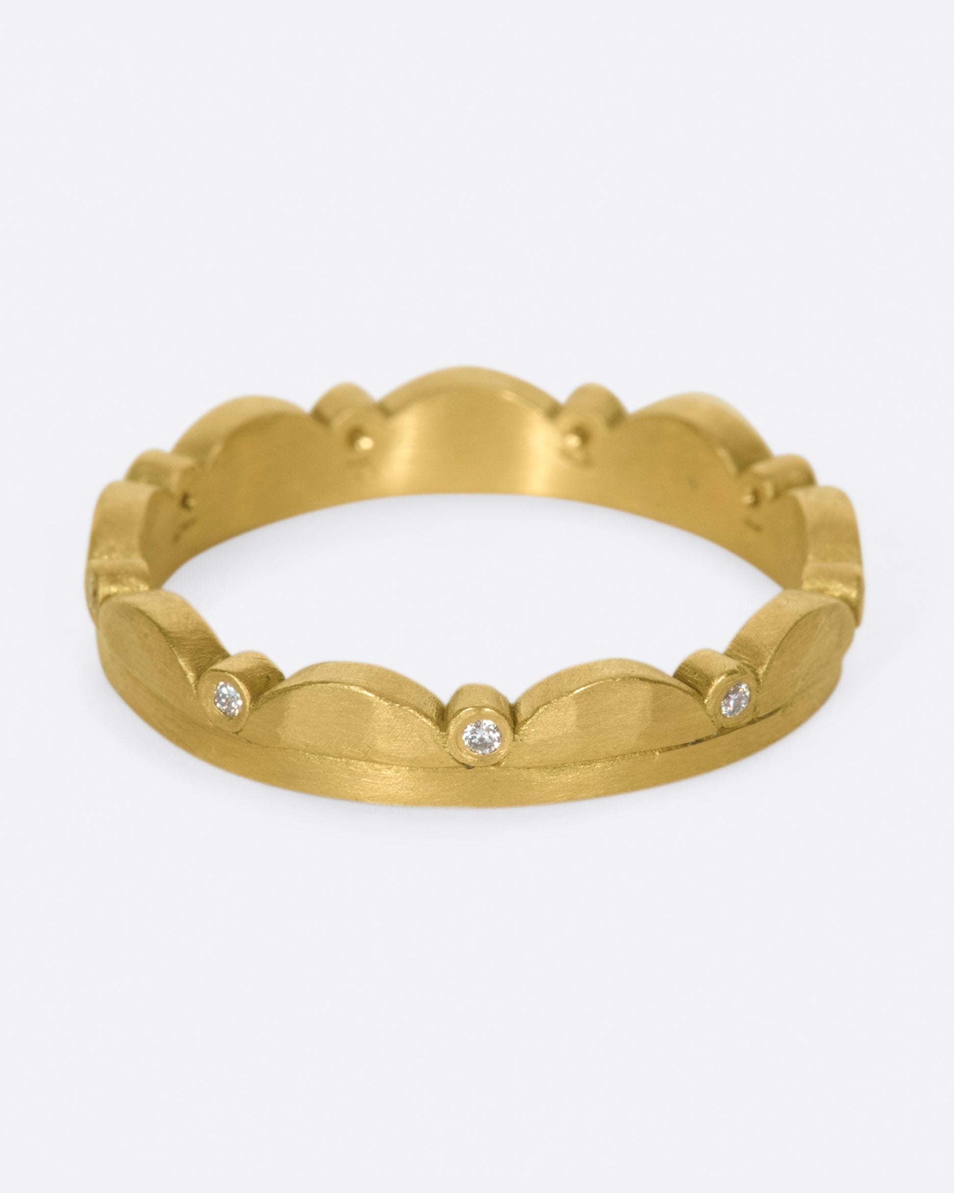 A delightful ring that's scalloped on one side, punctuated by sparkling inset diamonds.