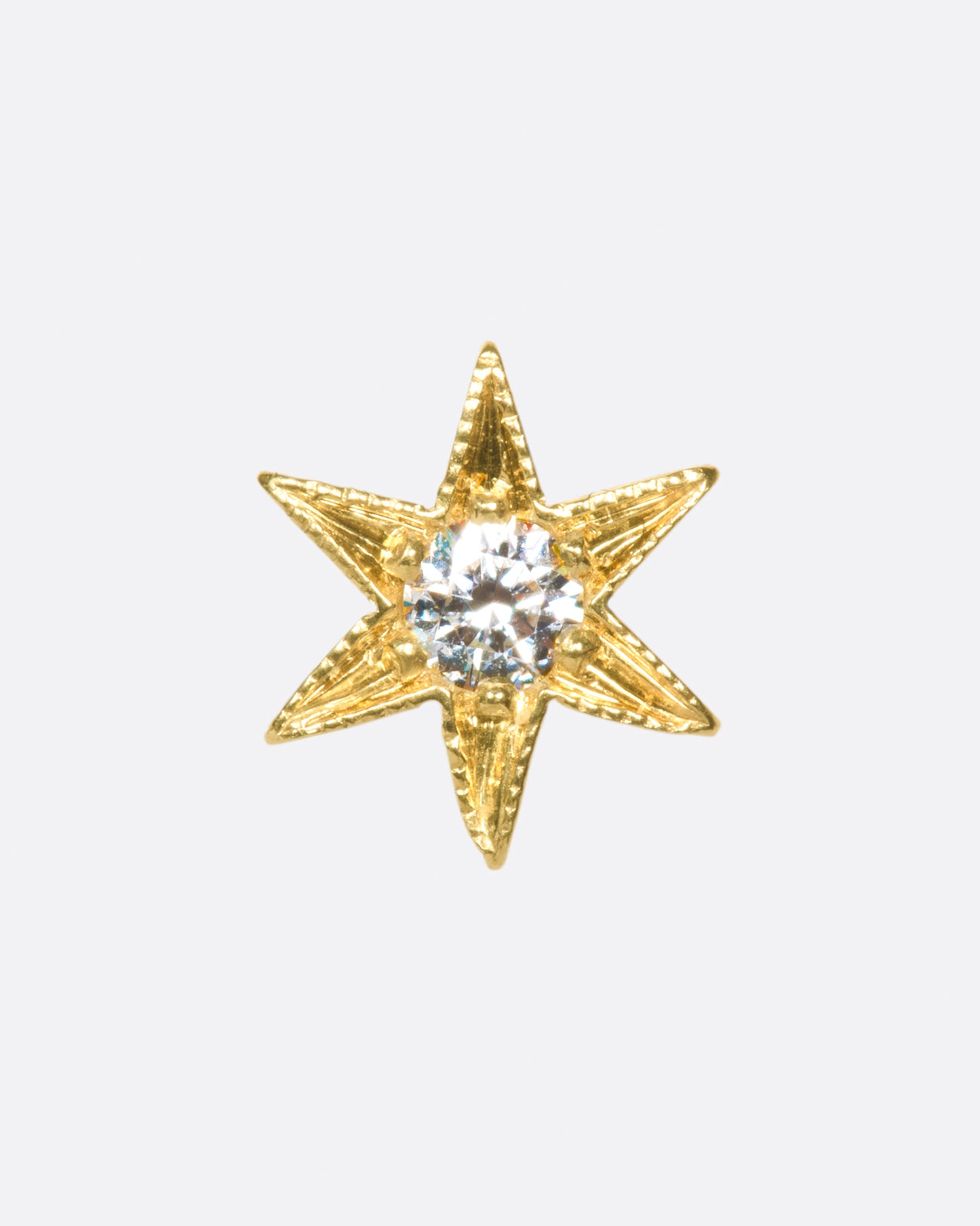 Yellow gold star stud earring with six points and millgrain details.