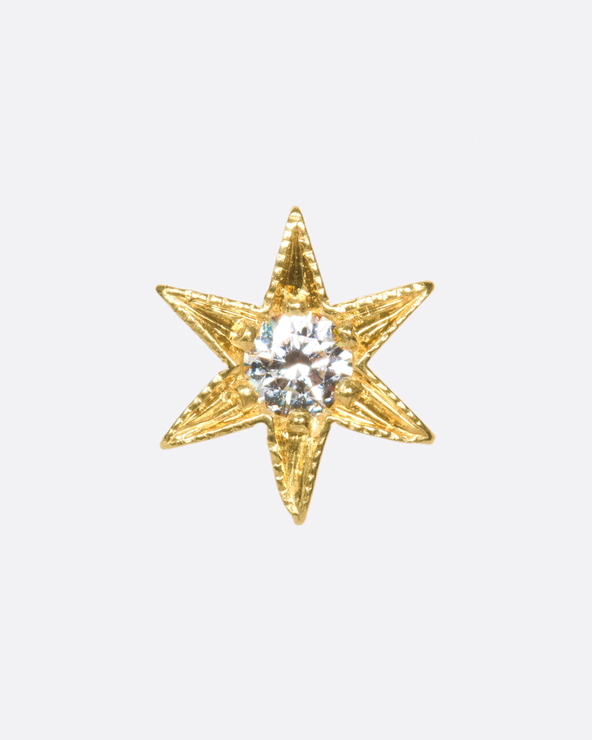 Yellow gold star stud earring with six points and millgrain details.