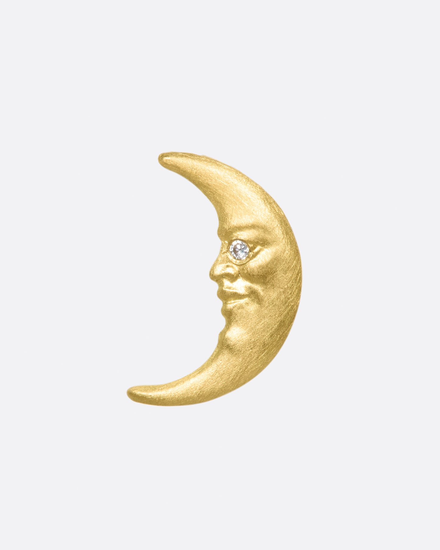 Anthony Lent calls his moonface "the moon of collective unconscious." Featuring diamond a diamond eye and a smirk, this moonface stud plays well with your other earrings.