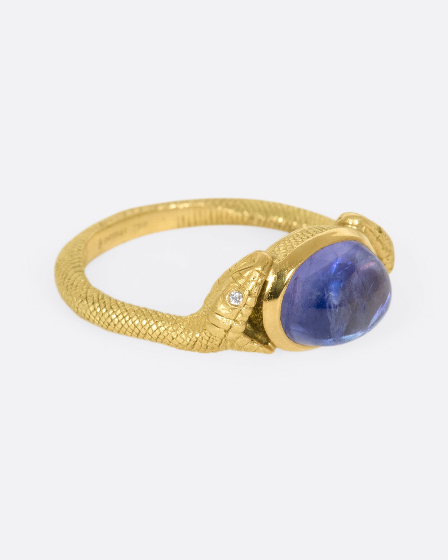 On the one hand, snakes represent Biblical personifications of evil, and on the other they symbolize health and healing; this pair encompass a saturated tanzanite cabochon.