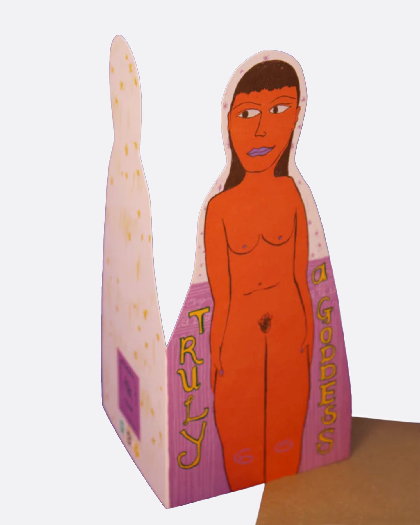 A greeting card in the shape of a nude woman with the words 'truly a goddess' on the front, and a blank interior. Shown with its kraft paper envelope.