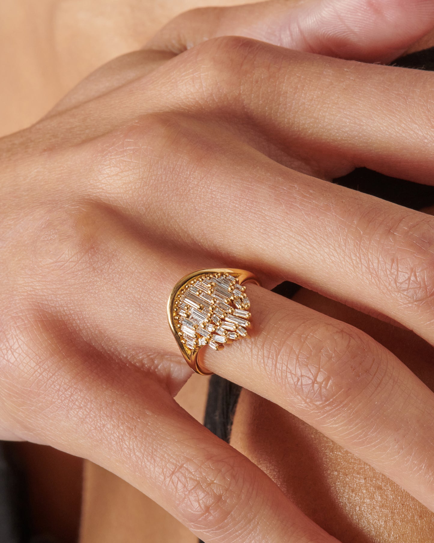 A semi-circular ring filled with diamond baguettes that grow slightly askew.
