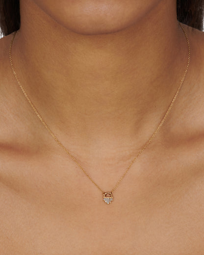 A curved gold pendant necklace with five diamond baguettes.