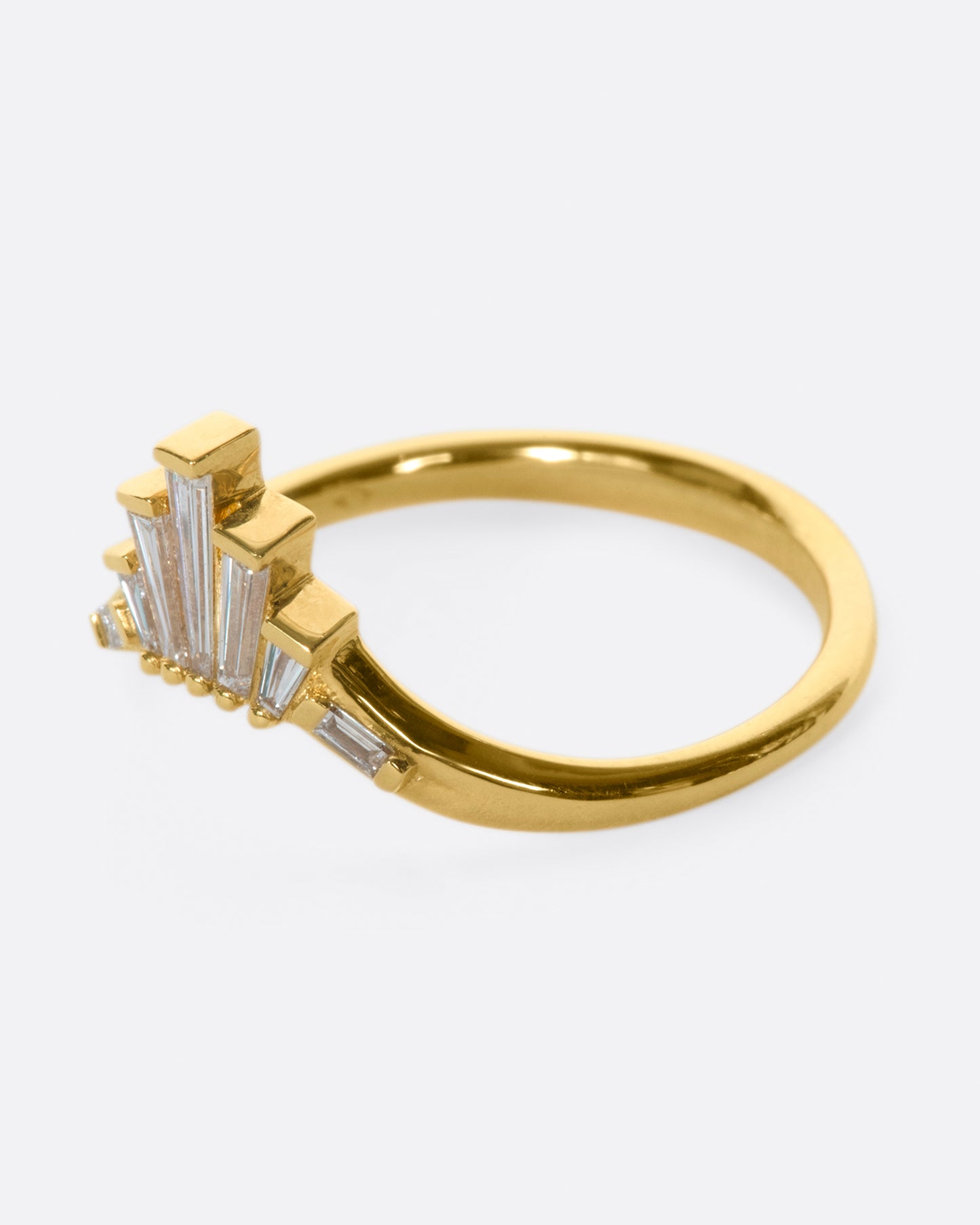 A nesting ring inspired by a twisting cityscape, created with elegant and edgy tapered white diamonds.