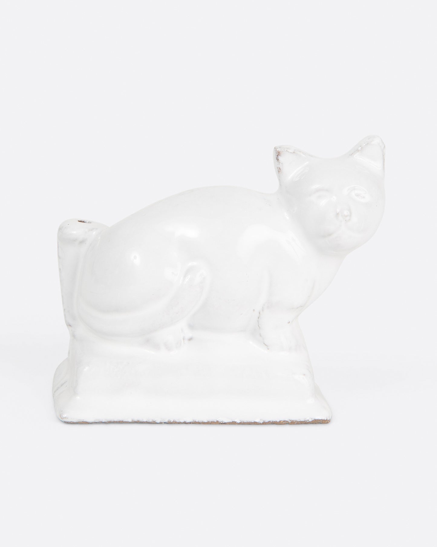 A glazed white ceramic cat-shaped incense holder, shown from the front.