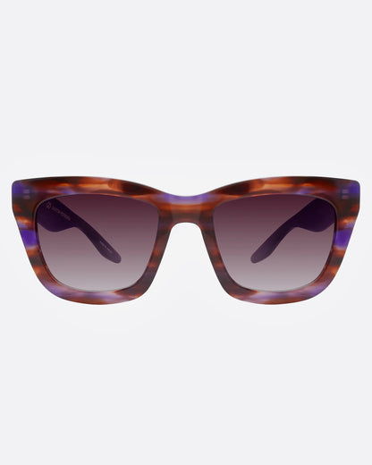 A pair of sunglasses with tortoiseshell frames with flecks of purple and gradient lenses, shown from the front.