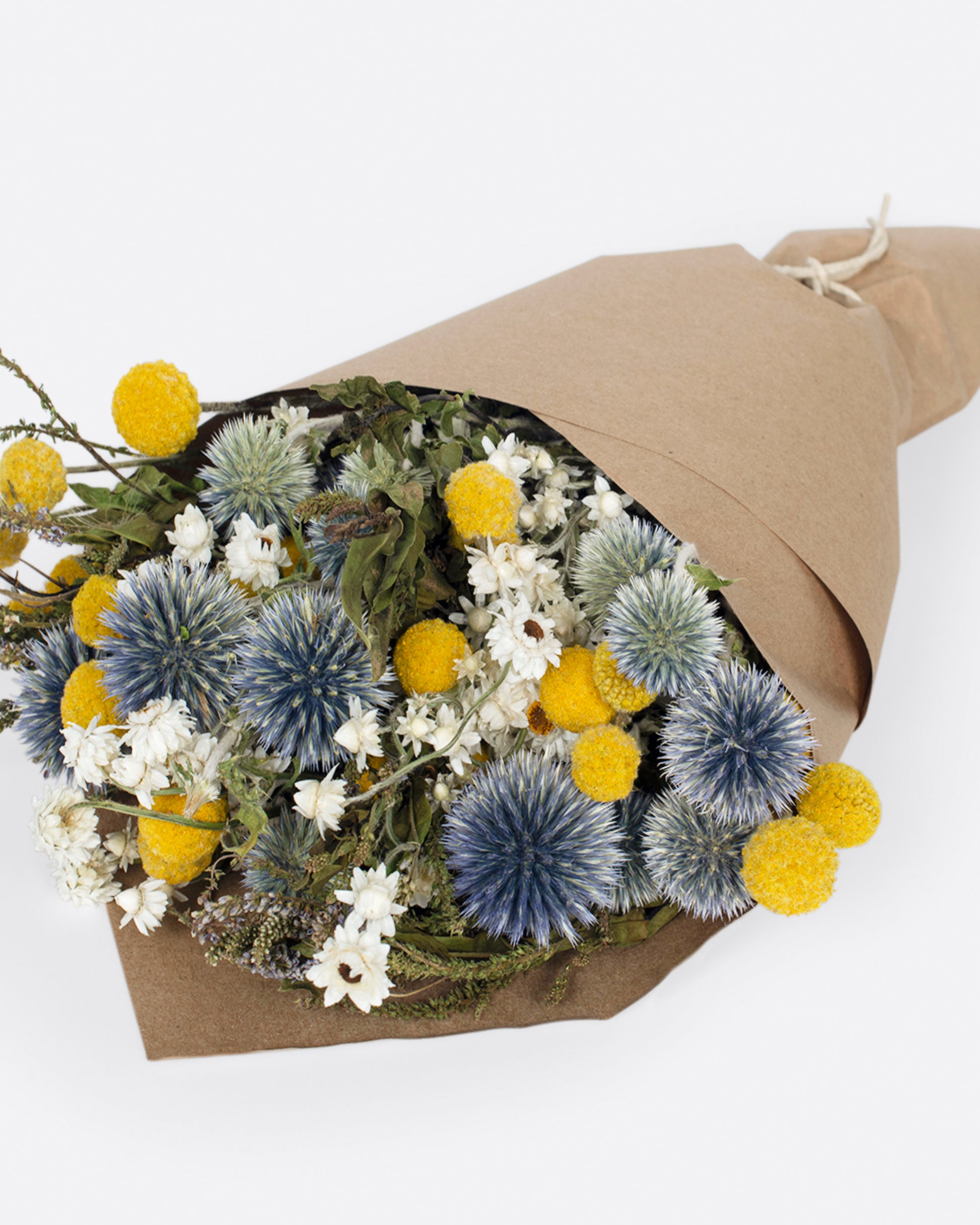 A hand arranged bouquet with assorted shades of yellow, green, and blue.