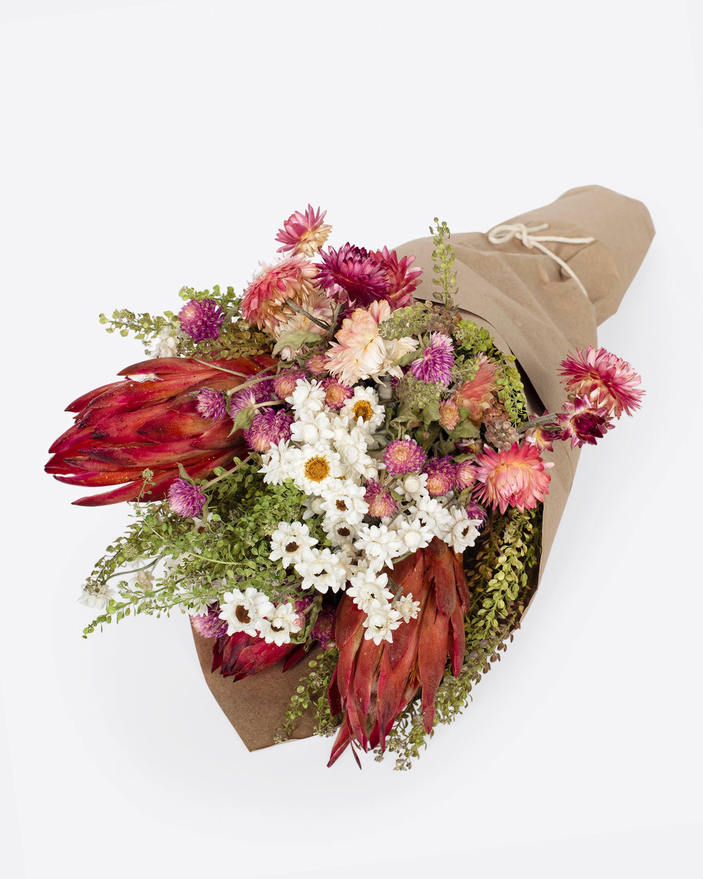 A dried flower bouquet in assorted shades of pink, white, and red.