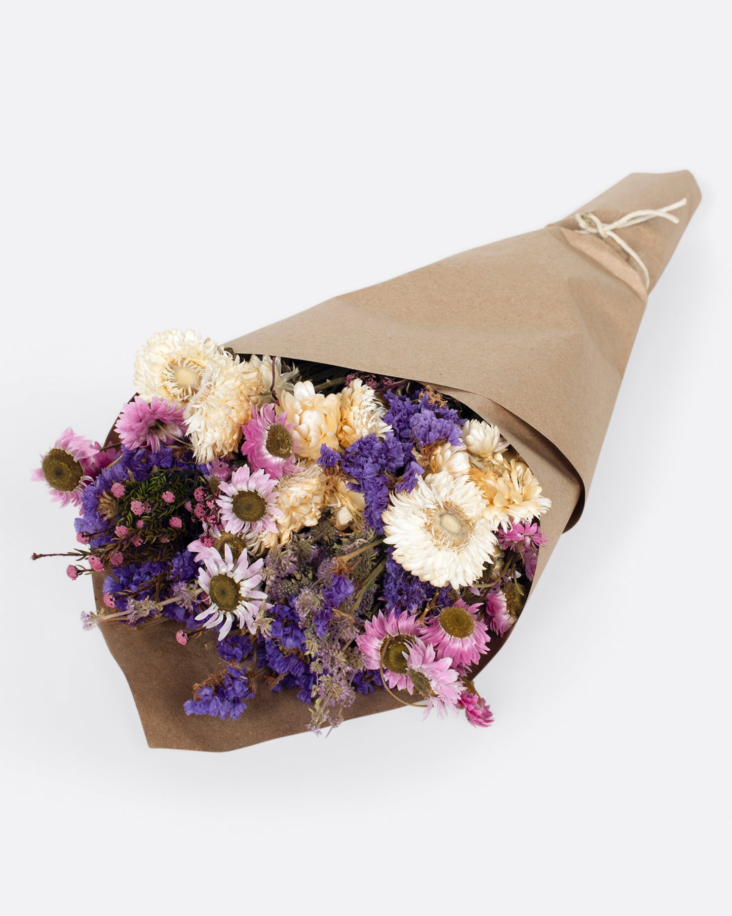 A handmade floral arrangement with purple, pink and white hues.