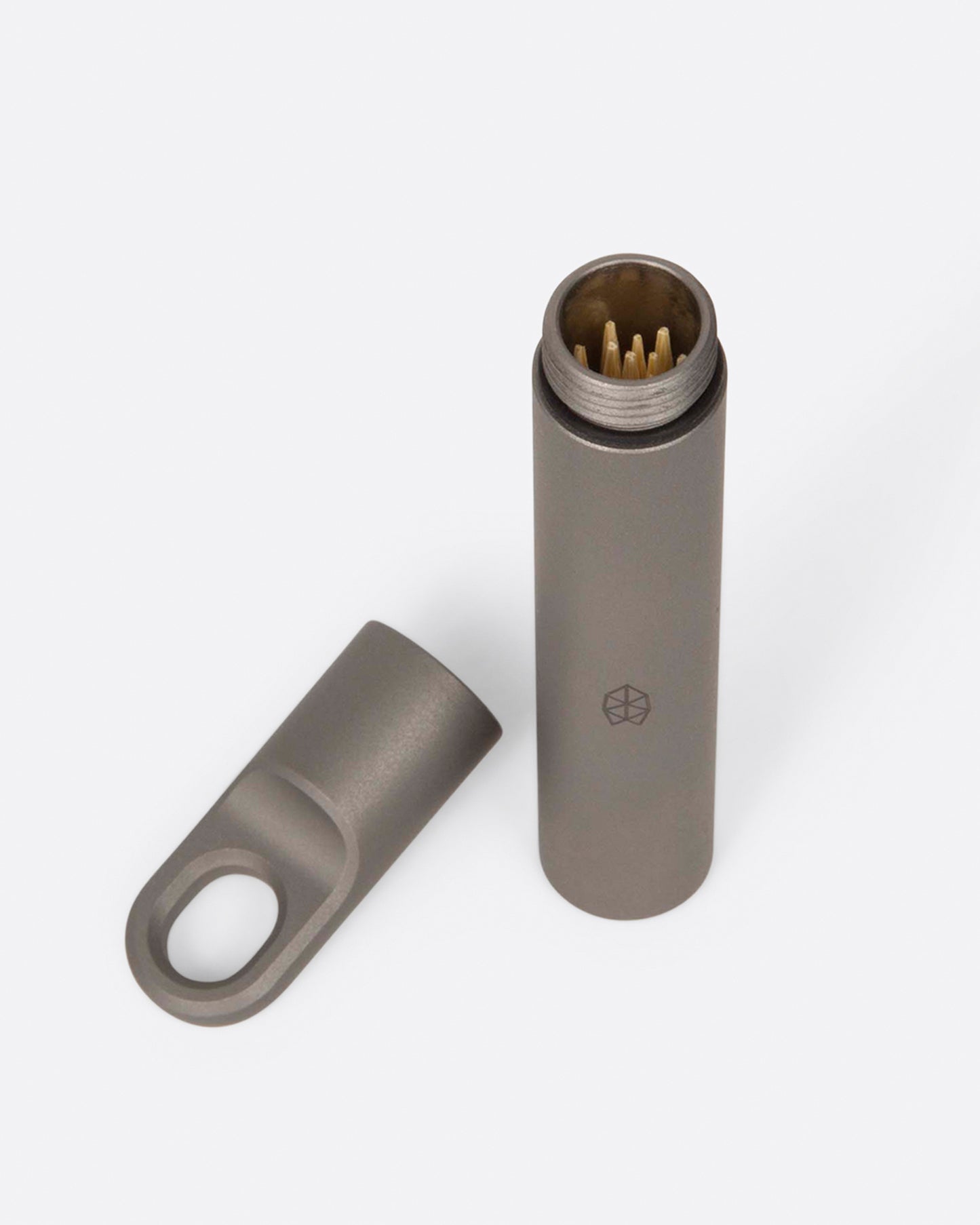 A pocket-size titanium canister shown from above with its lid off.