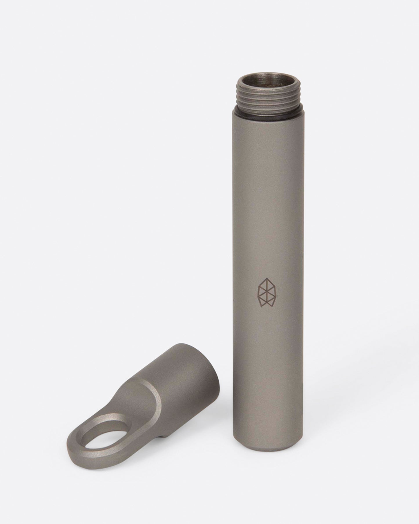 A pocket-size titanium canister shown with its lid off and toothpicks spilling out.