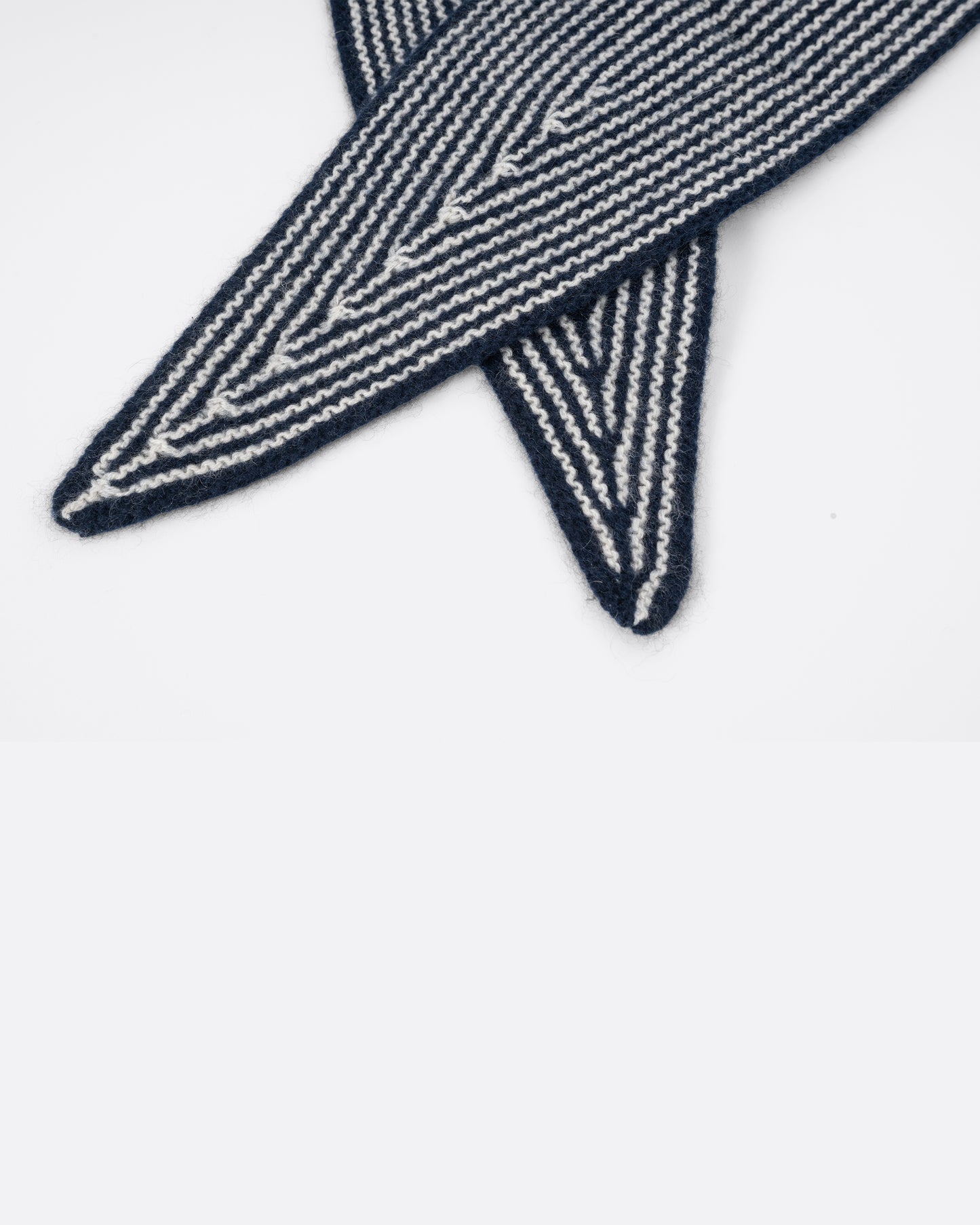 A navy striped cashmere scarf, shown close up. 