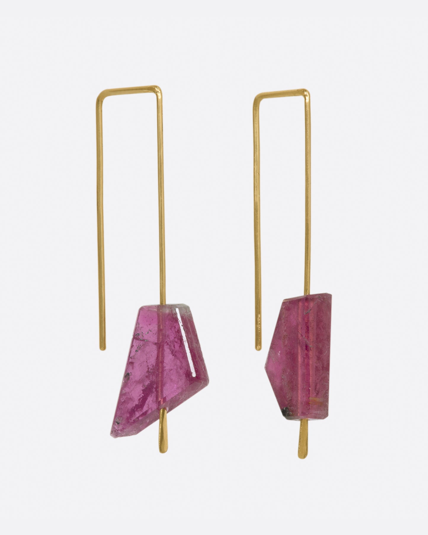 Yellow gold rectangular hook earrings with a single deep pink tourmaline on each. View from the side.