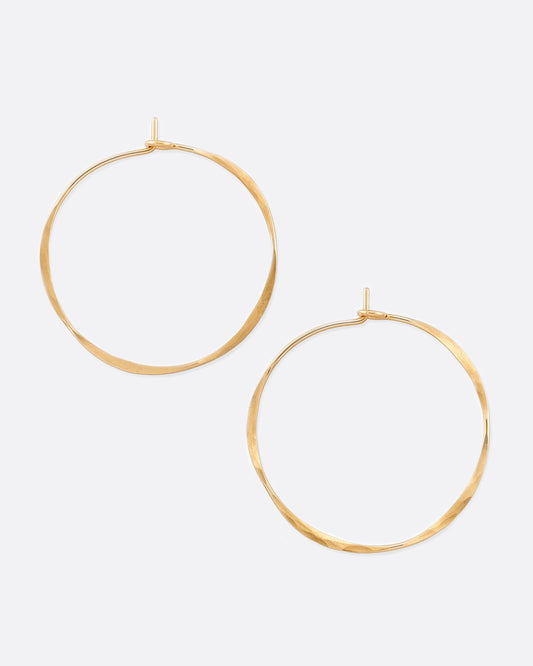 Hand-hammered yellow gold hoops with a comfortable hook closure.