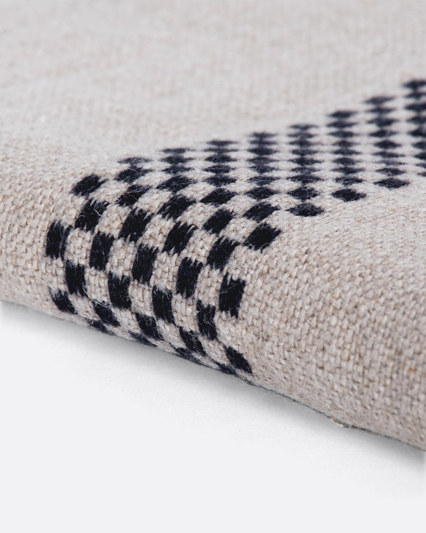 Natural linen napkin with black checkered embroidery