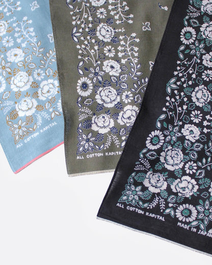 Three floral-patterned bandanas in blue, green, and black, shown close up.