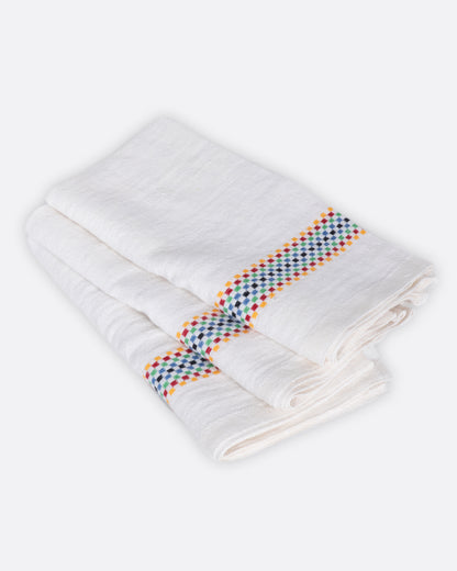 White linen napkin with multicolor stripe, folded at an angle