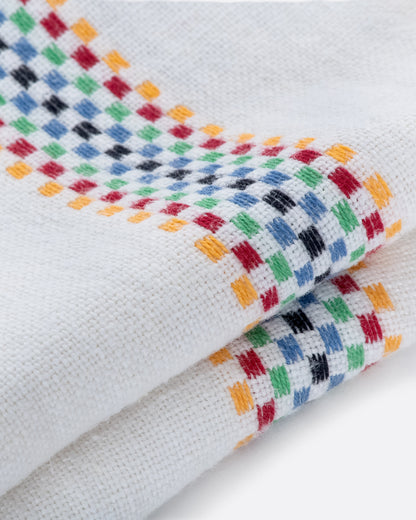 Charvet Editions Lustucru napkin in white linen, with a multicolor checkered woven stripe