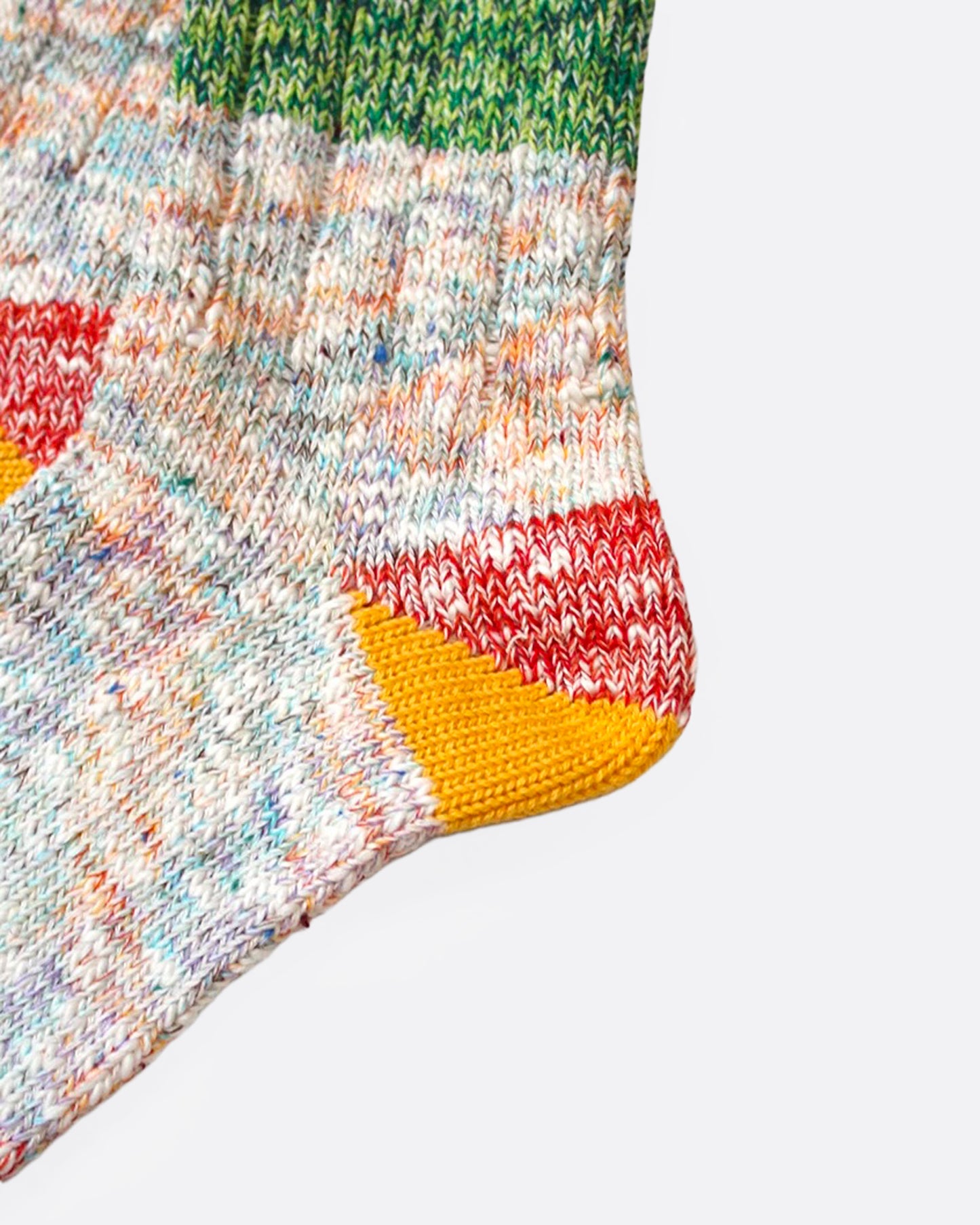 A close up of a pair of multicolored marl socks with dual-toned heels, shown from the side.