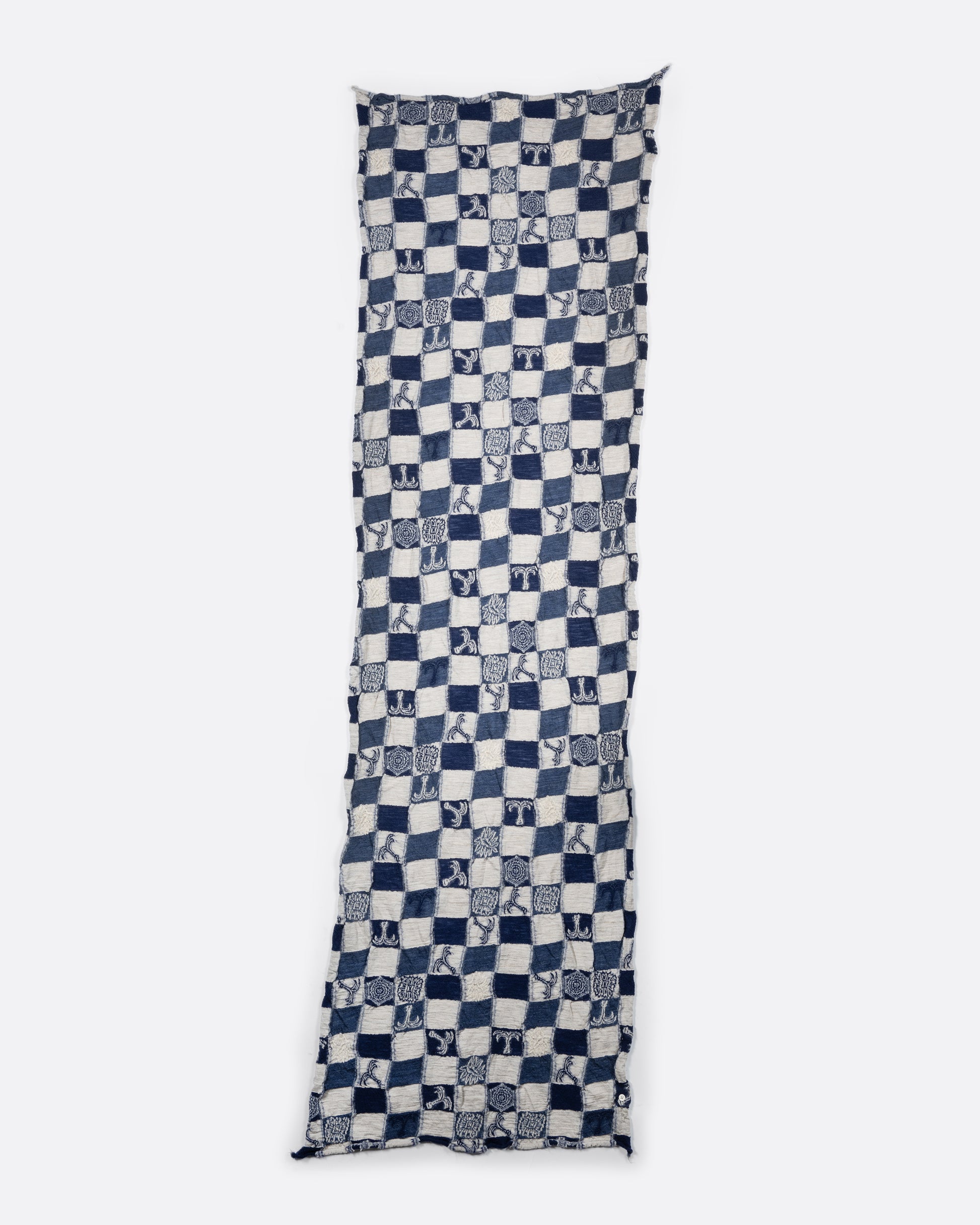 A grey and navy blue checkered scarf with a nautical print. Shown laying flat.