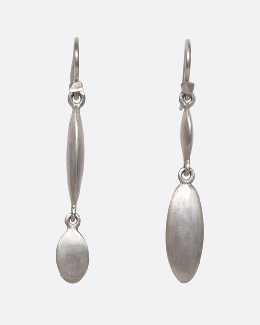 These asymmetrical dangles juxtapose a flat circle with a razor-thin oval in a luscious matte finish