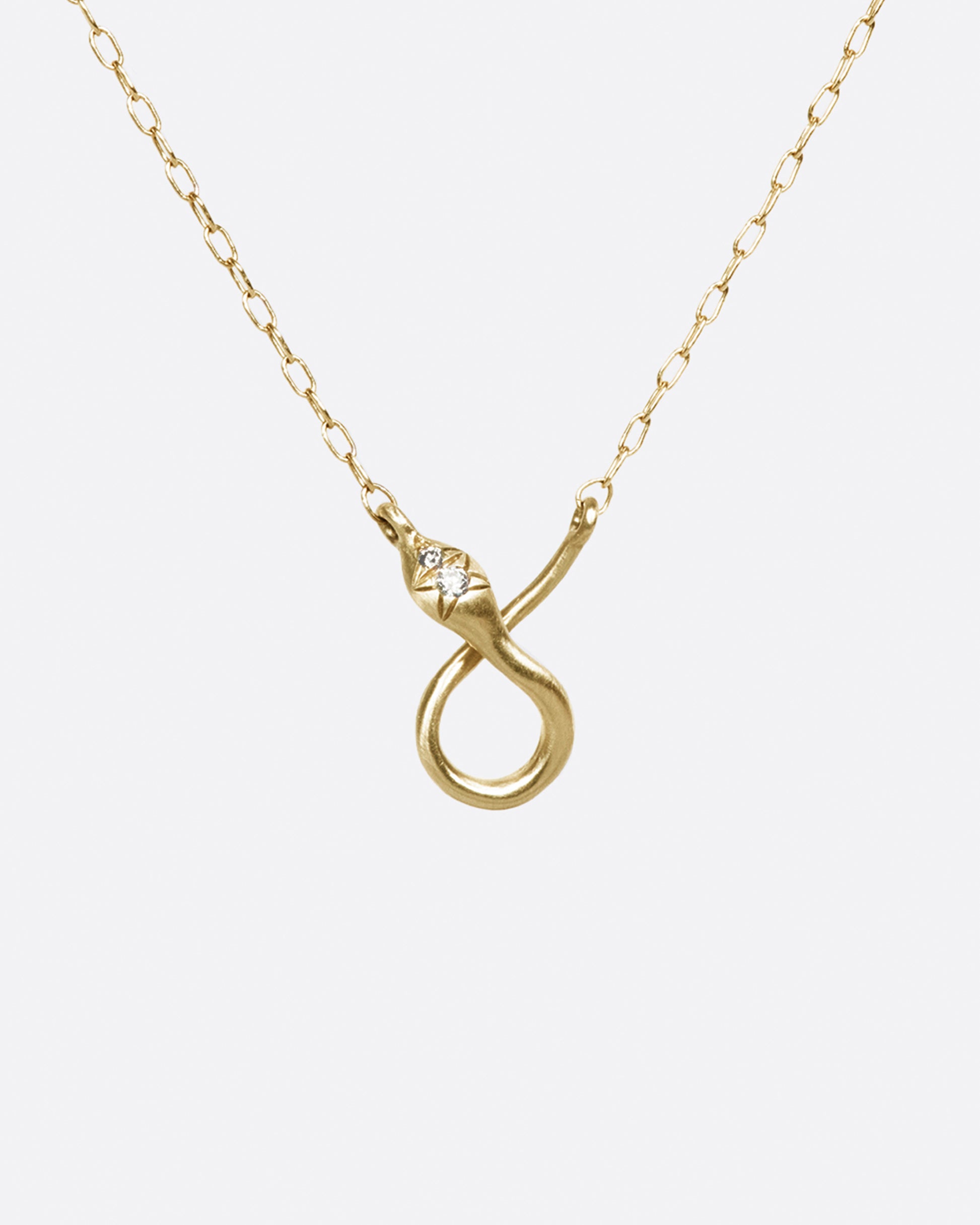 Wear this snake pendant necklace with your favorite charms; thread them on the chain and let them rest at the base of the curve.
