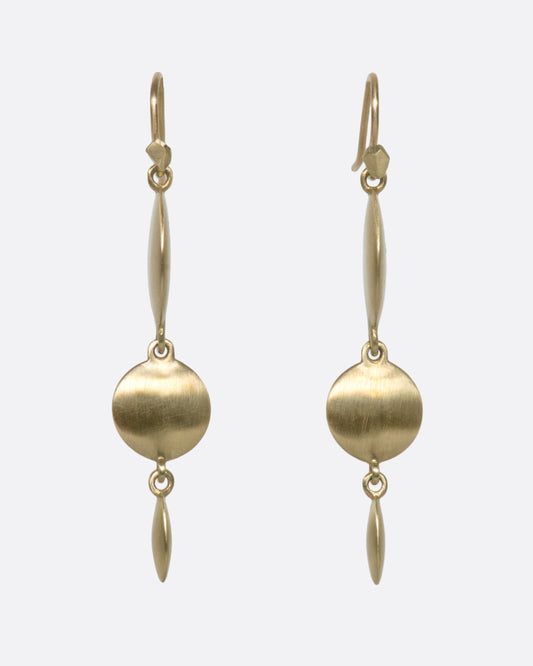 These unusual triple drop brushed gold earrings have impressive razor thin edges that make them look different from every angle