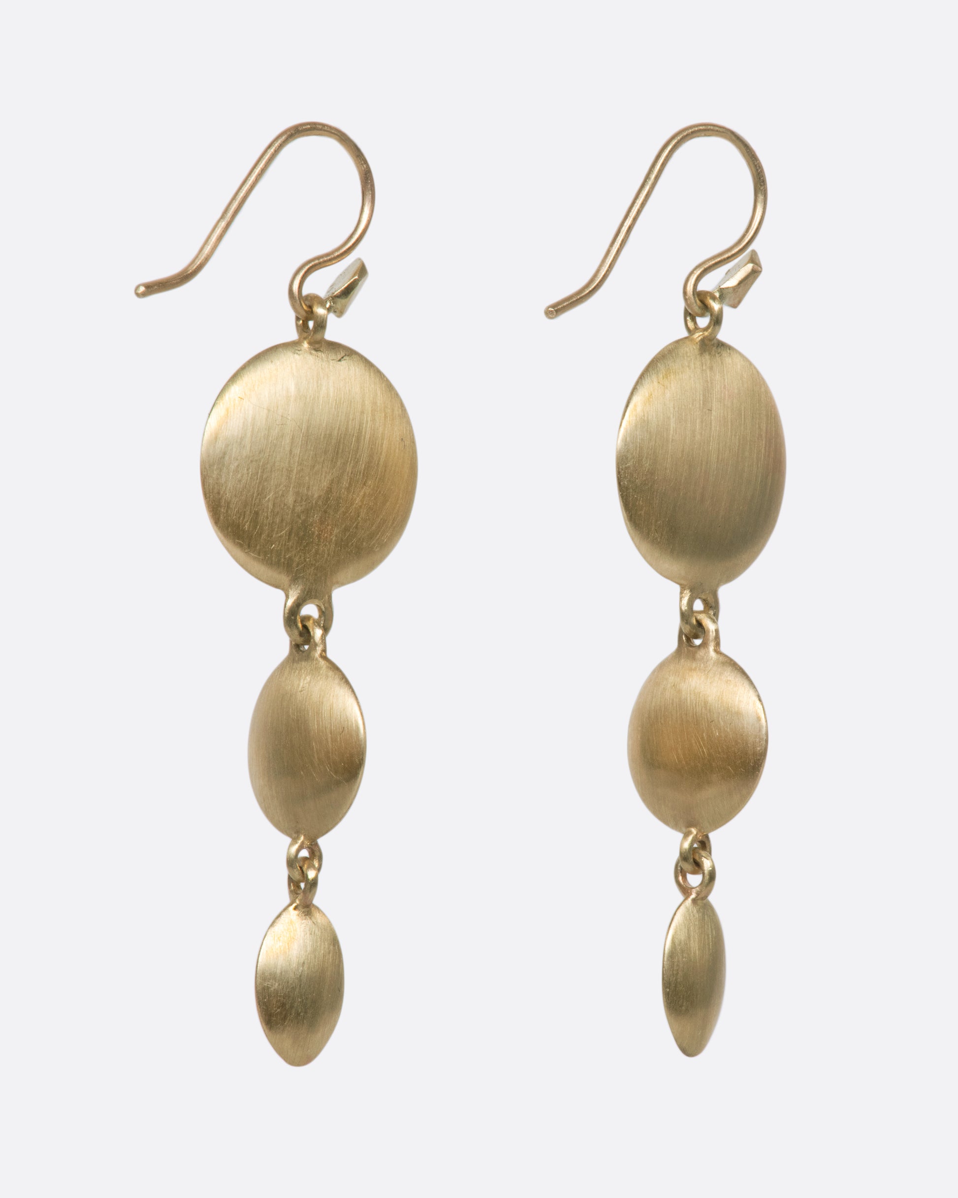 These unusual triple drop brushed gold earrings have impressive razor thin edges that make them look different from every angle
