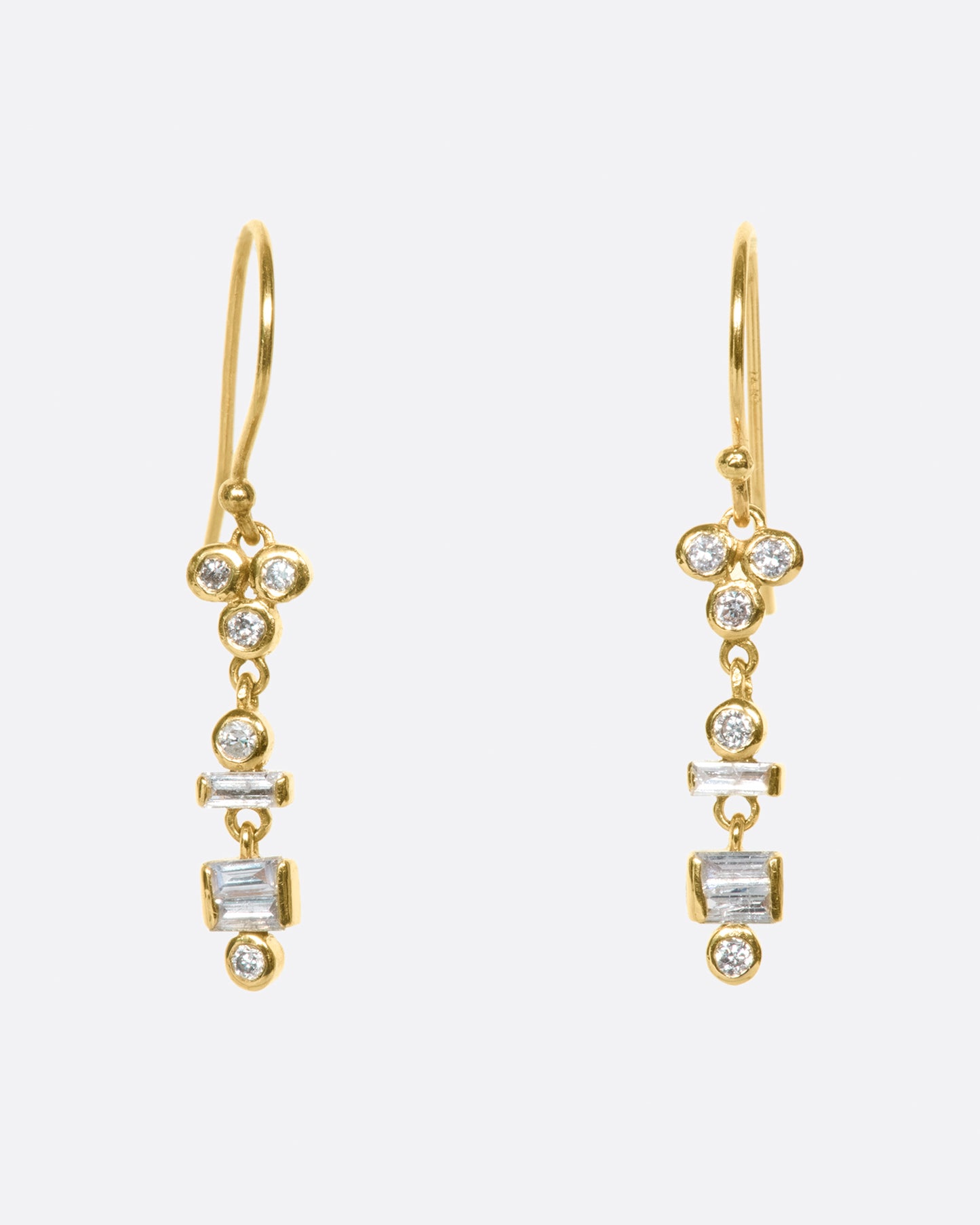 A pair of diamond totem drop earrings with layers of round and diamond baguettes.