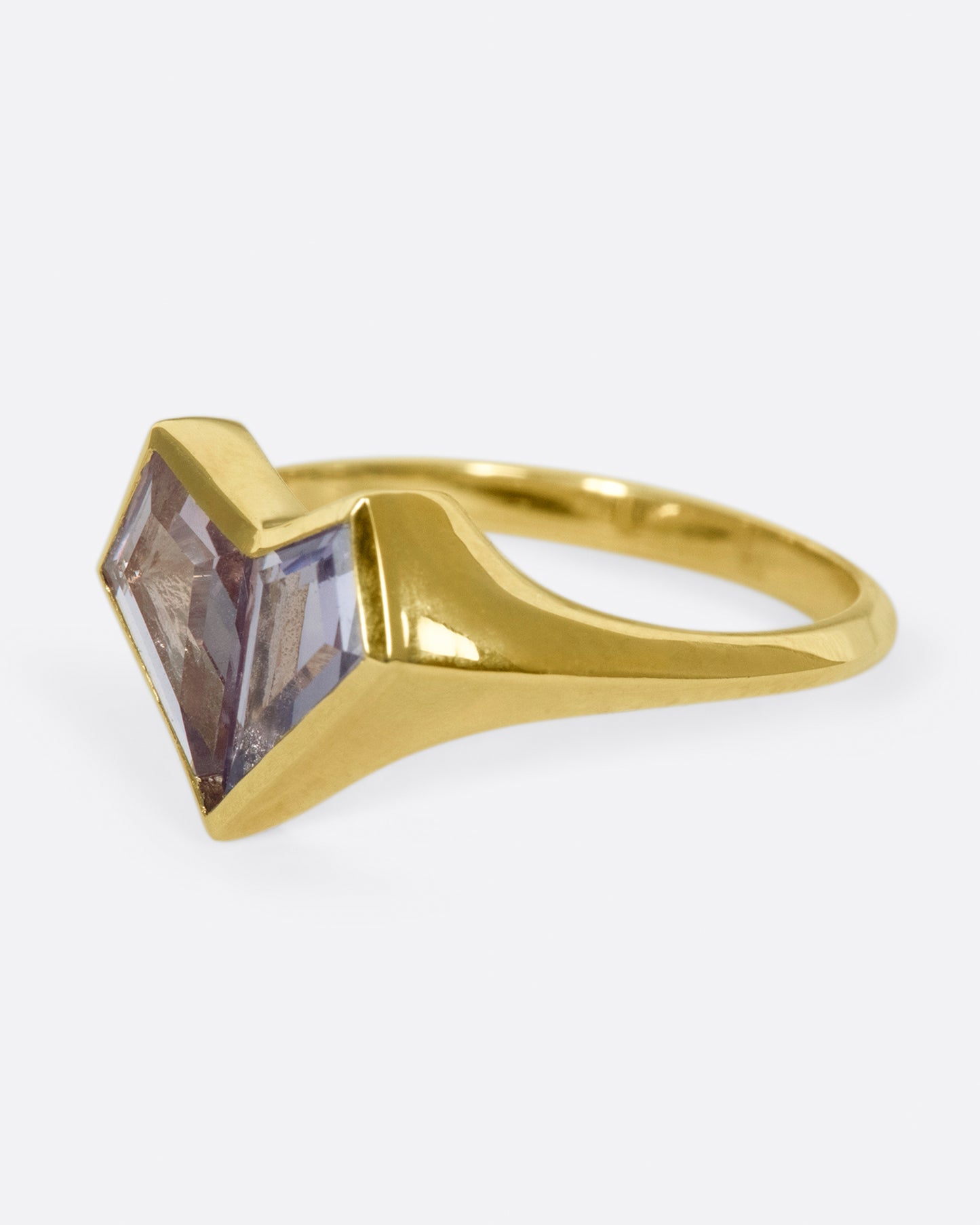 Two kite shaped sapphires; one pale pink and one purple; come together to form a heart on this signet ring.