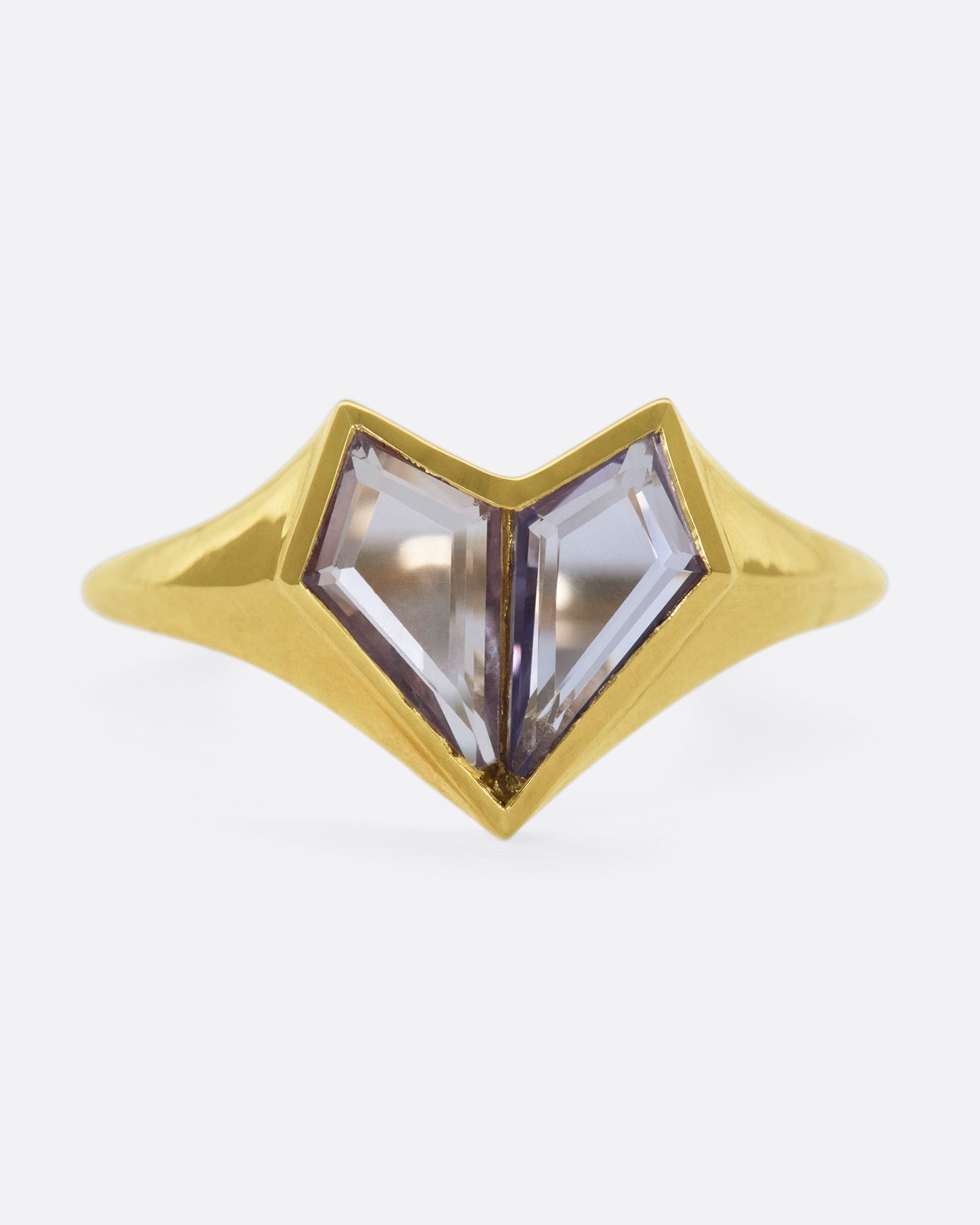 Two kite shaped sapphires; one pale pink and one purple; come together to form a heart on this signet ring.