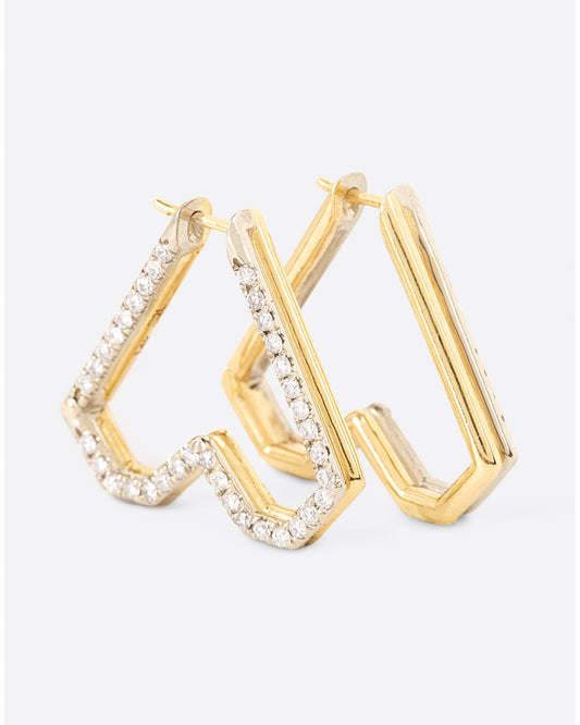 Two-tone 14k yellow and white gold heart hoops lined with beautiful pave diamonds.Two-tone 14k yellow and white gold heart hoops lined with beautiful pave diamonds.