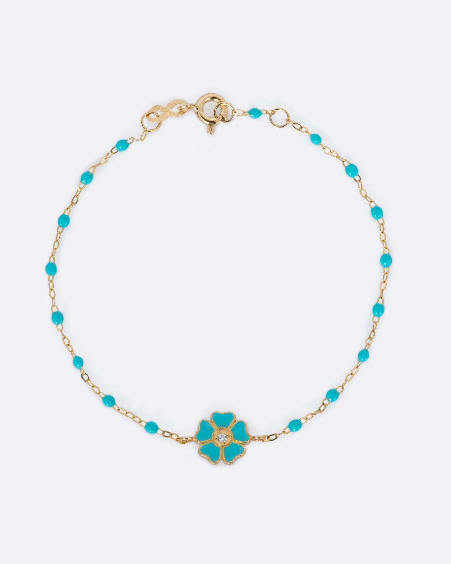 A yellow gold and turquoise green resin Gigi Clozeau bracelet with a flower and a diamond at its center