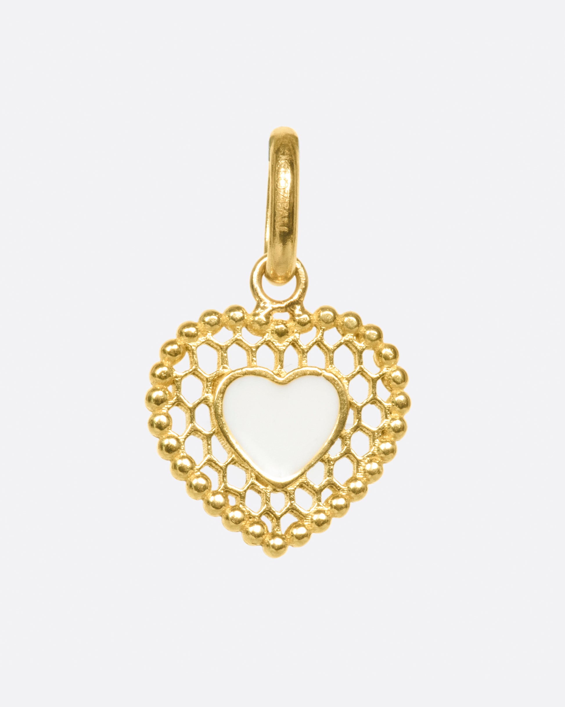 A vintage inspired heart charm that's still cool and new with its cutout details.