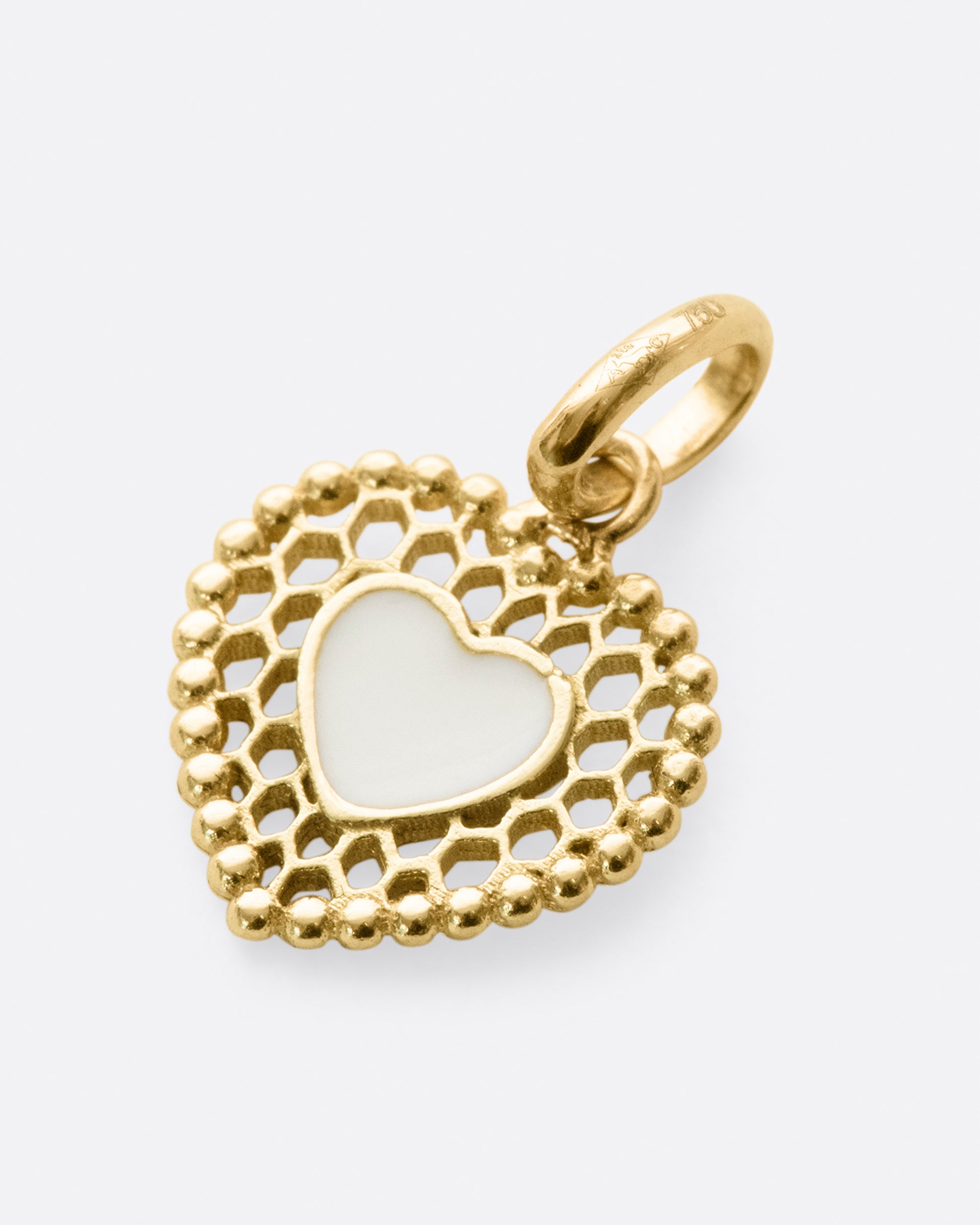 A vintage inspired heart charm that's still cool and new with its cutout details.