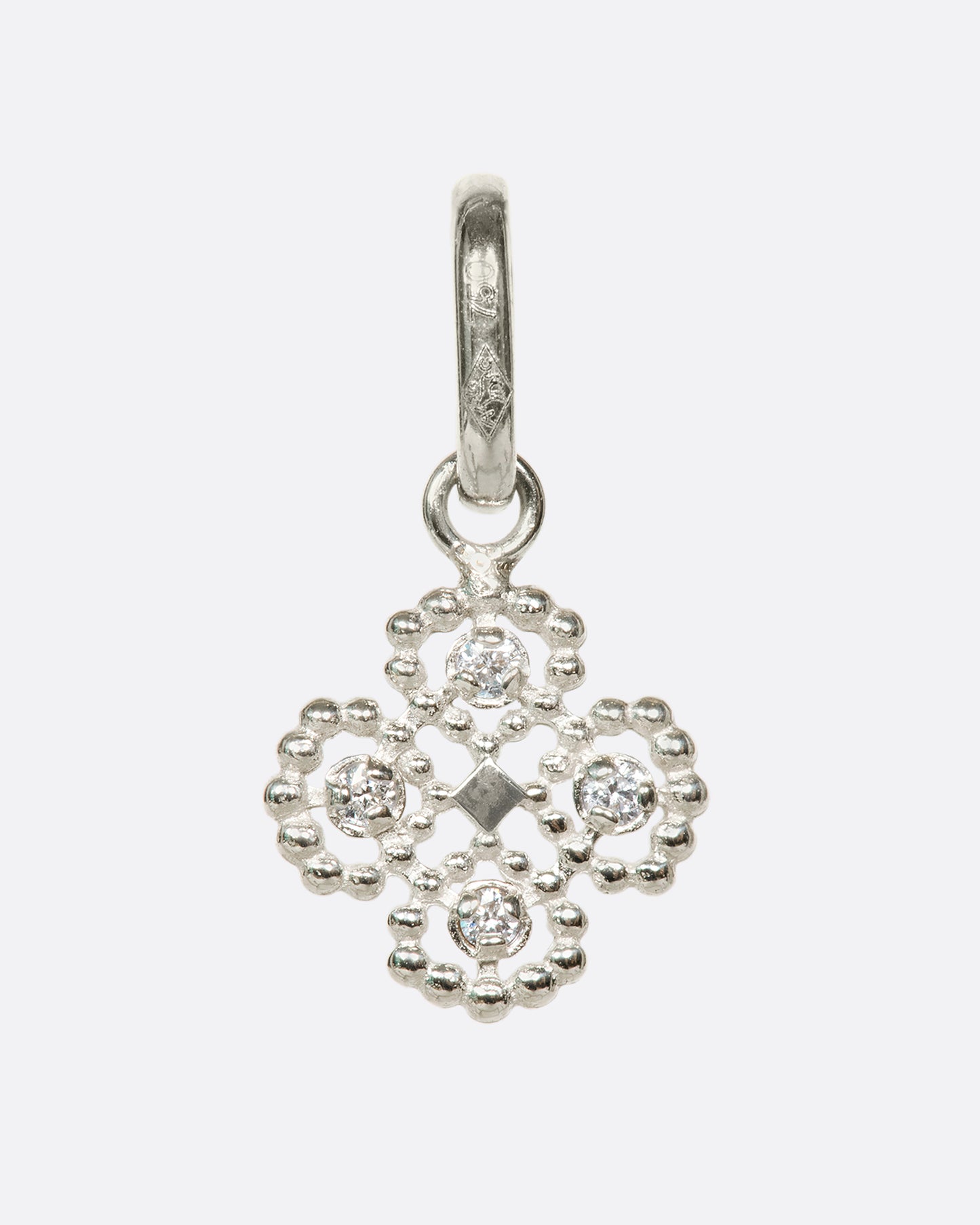 An 18k white gold clover pendant with round diamond details