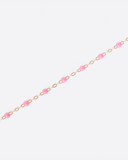 Rose gold resin bead bracelet laid out straight in pink