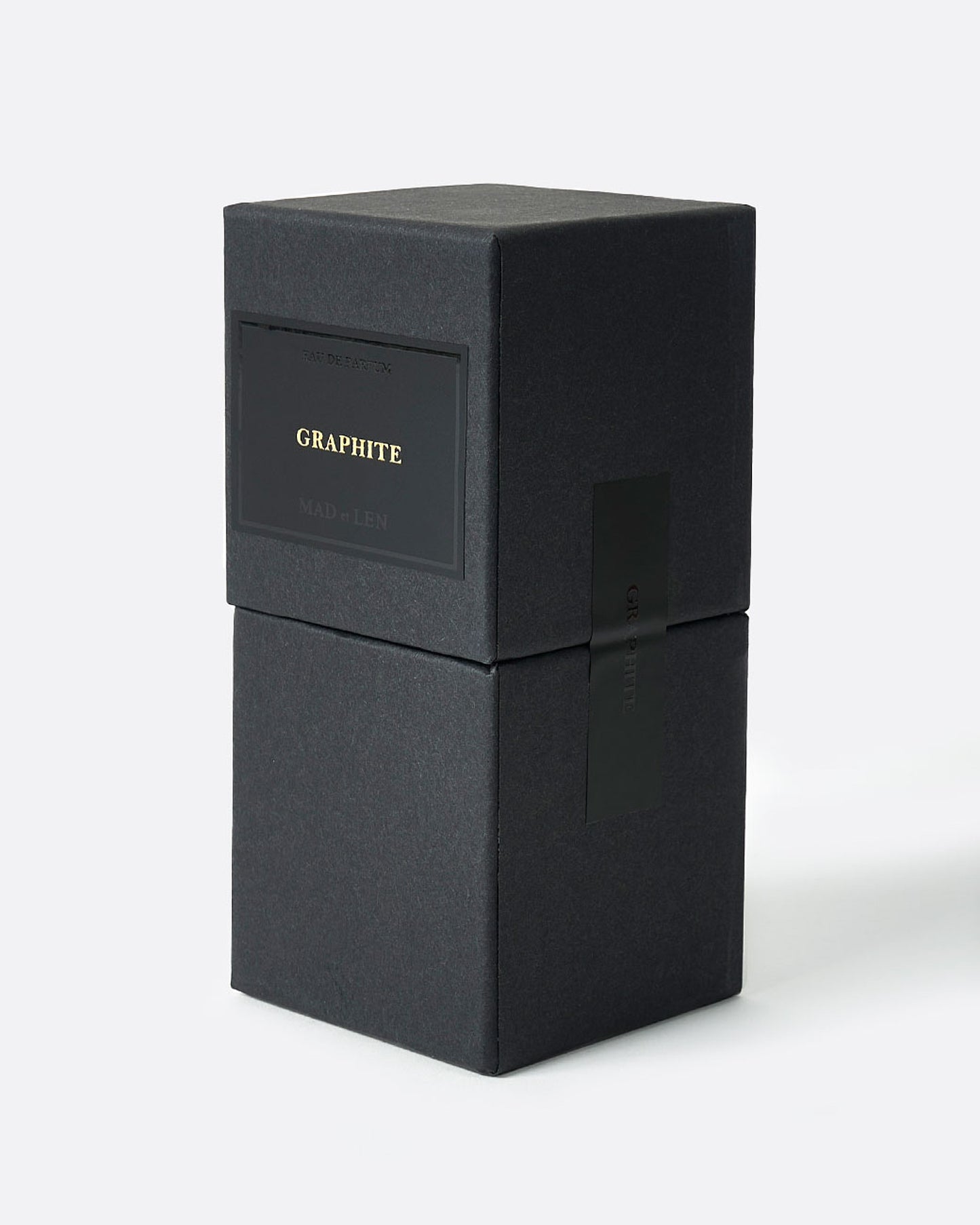 A bottle of Mad et Len's Graphite perfume in its box packaging.