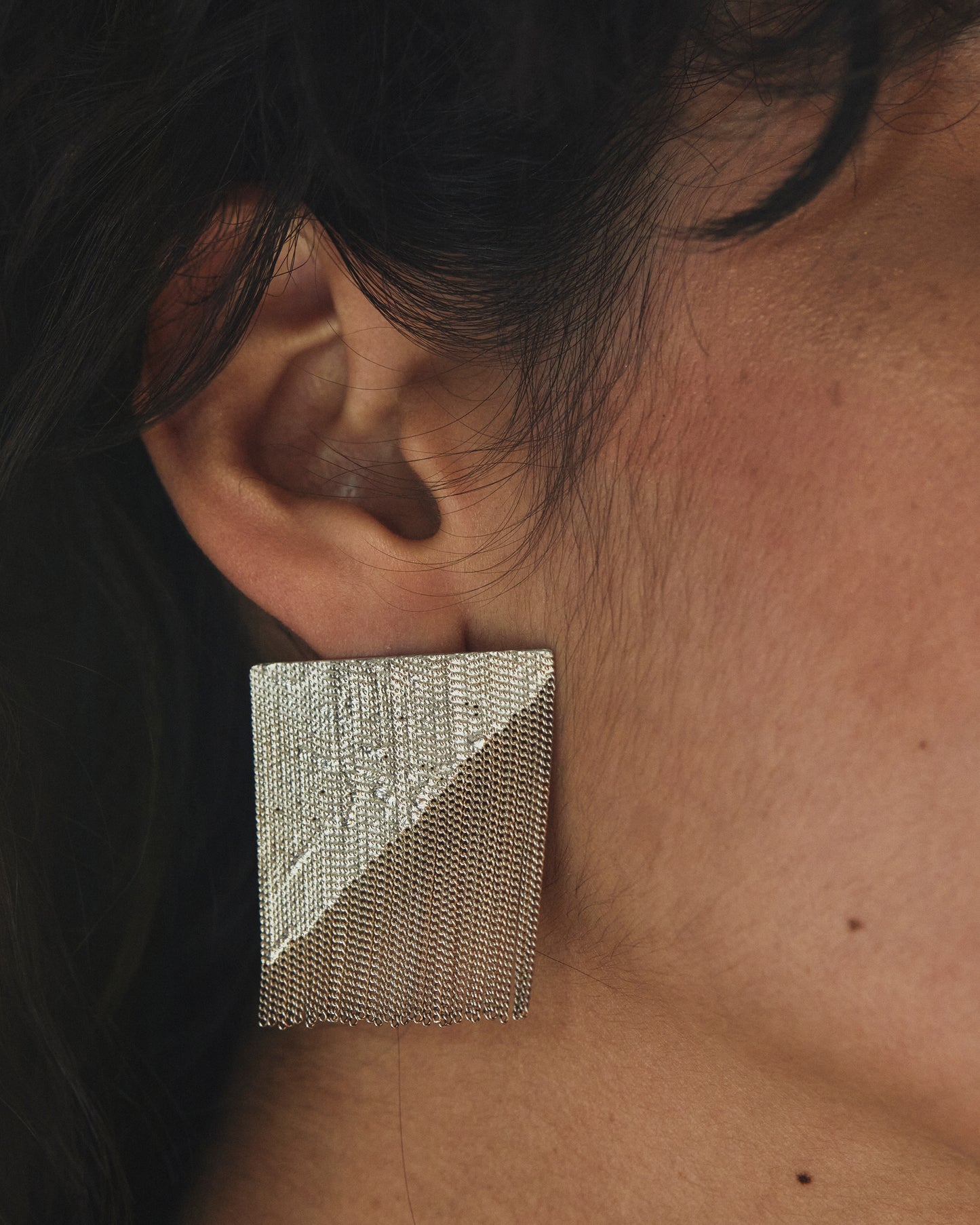 Large square earrings, with a diagonal line that separates chain from solid for a unique 70's inspired style.