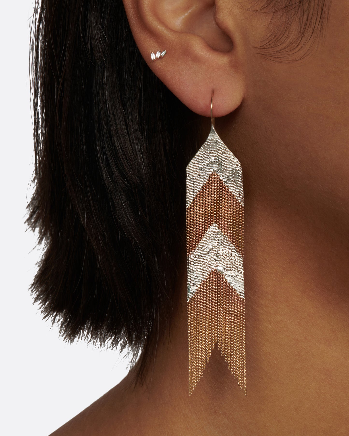 A pair of mixed metal chain fringe earrings in the shape of an arrow.