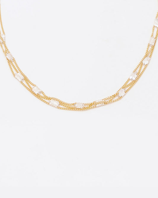 A necklace composed of three solid 18k yellow gold chains connected with sterling silver squares