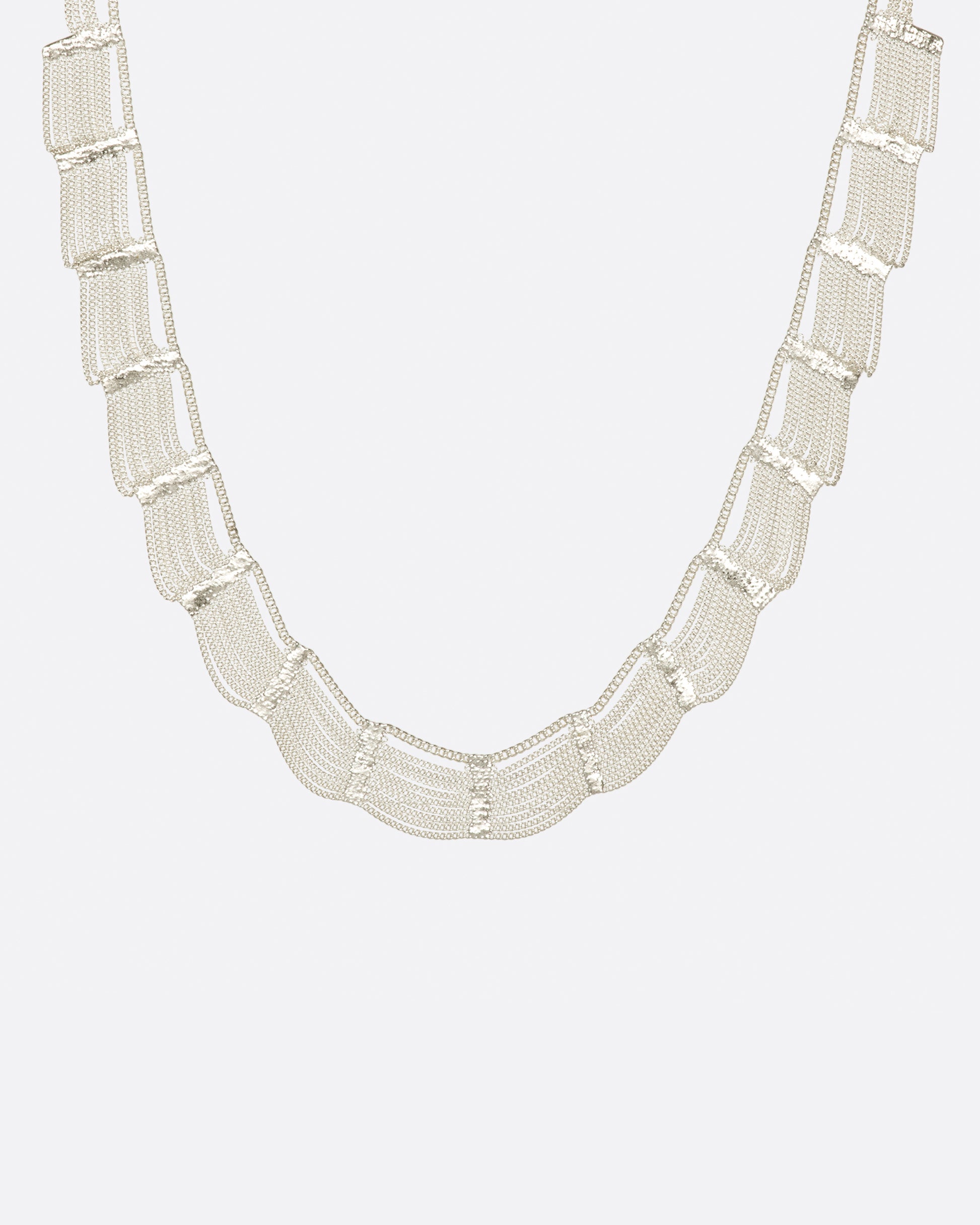 A sterling silver, fringy necklace with silver soldered sections to create a scalloped effect.